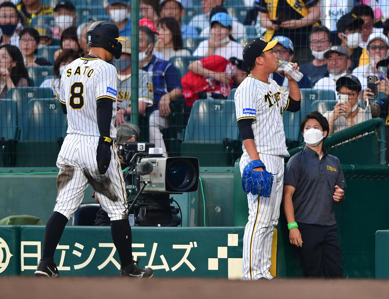 阪神対広島　5回表の登板を前に水分補給する阪神桐敷（右）、左は二盗失敗の佐藤輝（撮影・清水貴仁）