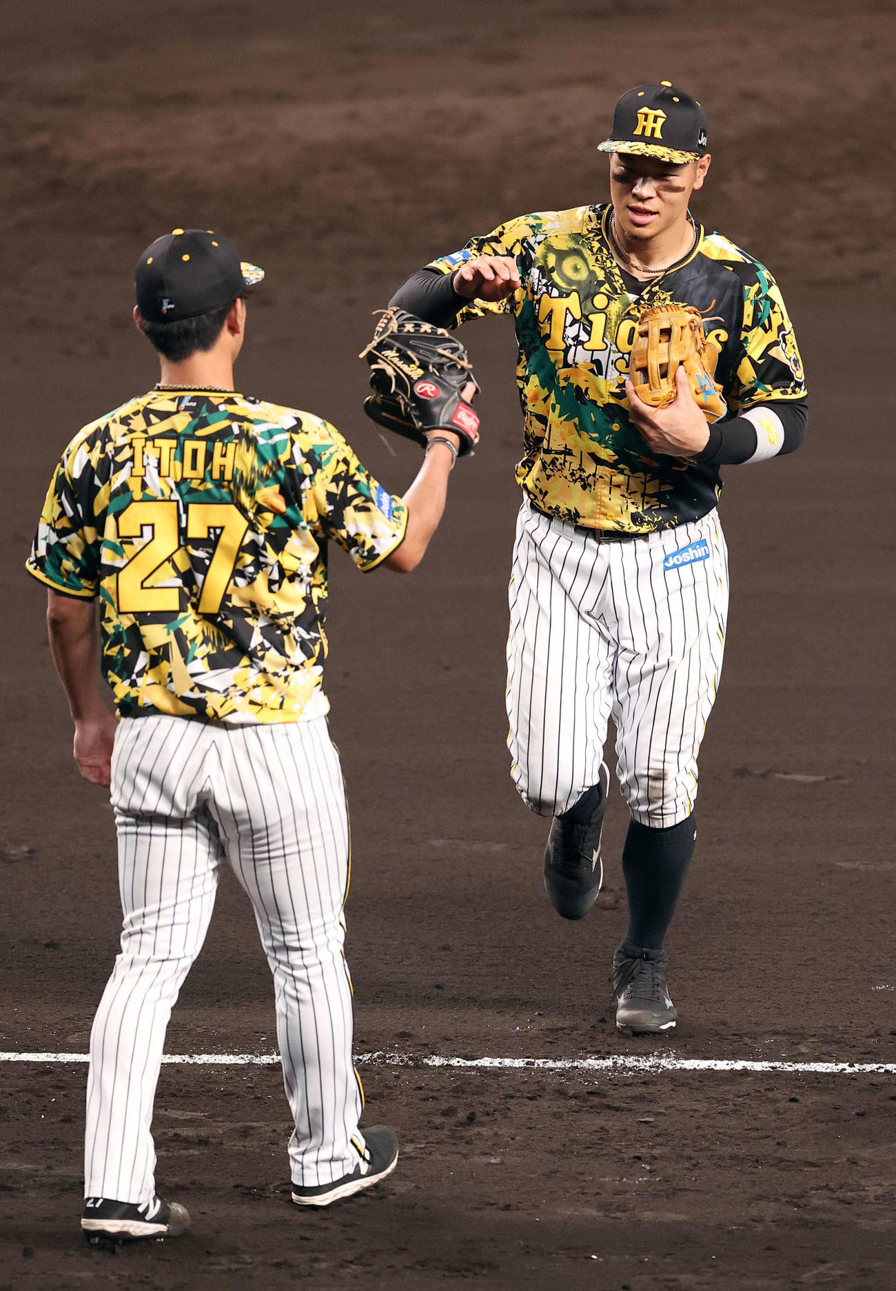 阪神対巨人　7回、軽快な守備を見せた佐藤輝（右）は先発伊藤将とハイタッチする（撮影・上田博志）
