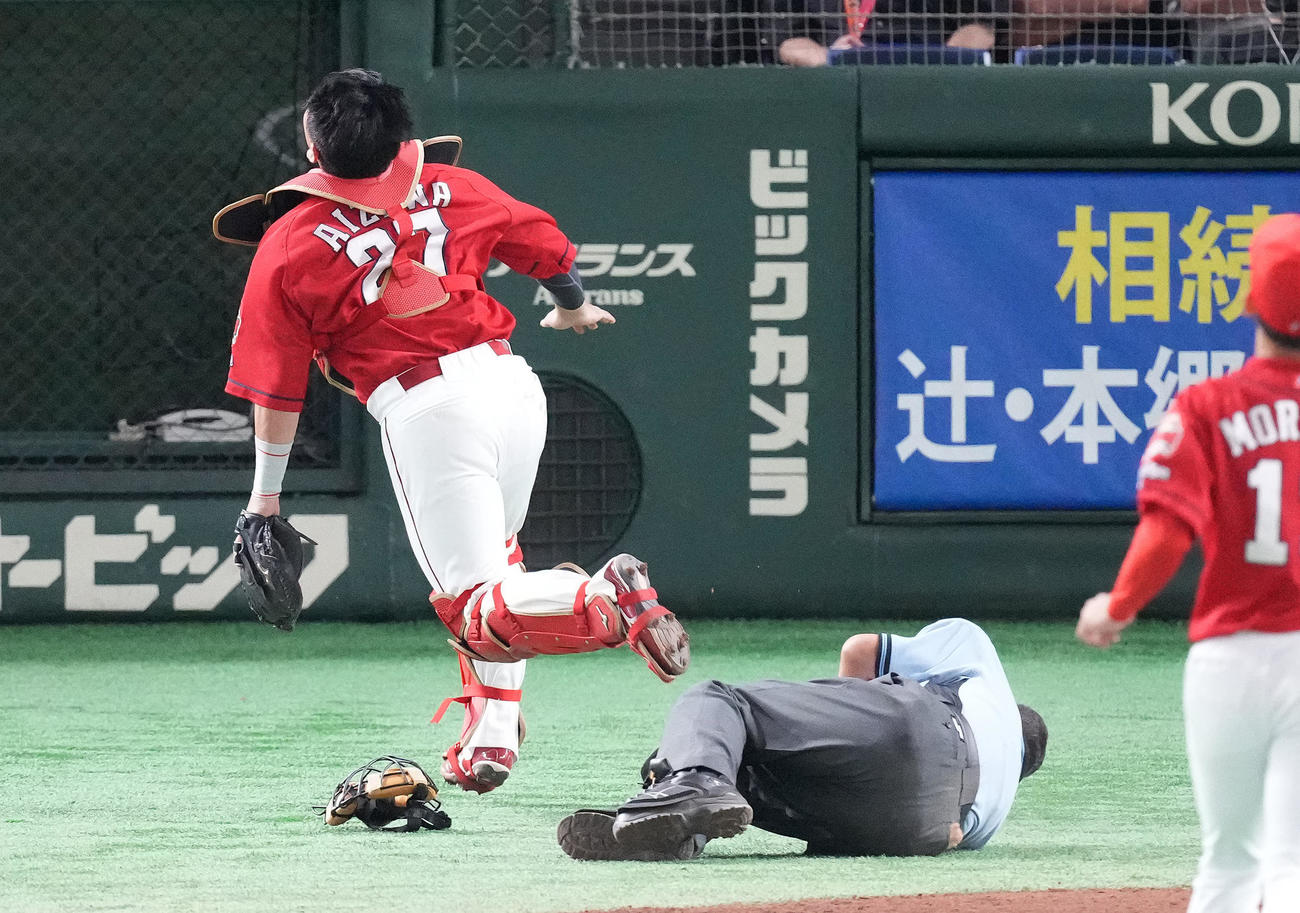 巨人対広島　8回裏巨人2死一、三塁、森球審をまたぎながら大城のファウル球を追う捕手会沢（撮影・鈴木みどり）