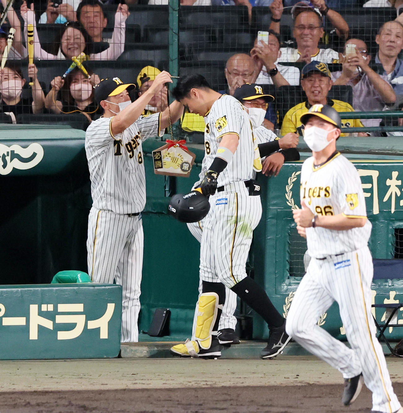 阪神対DeNA 6回裏阪神2死二塁、矢野監督（左）は中越え2点本塁打を放った佐藤輝にメダルをかける（撮影・加藤哉）