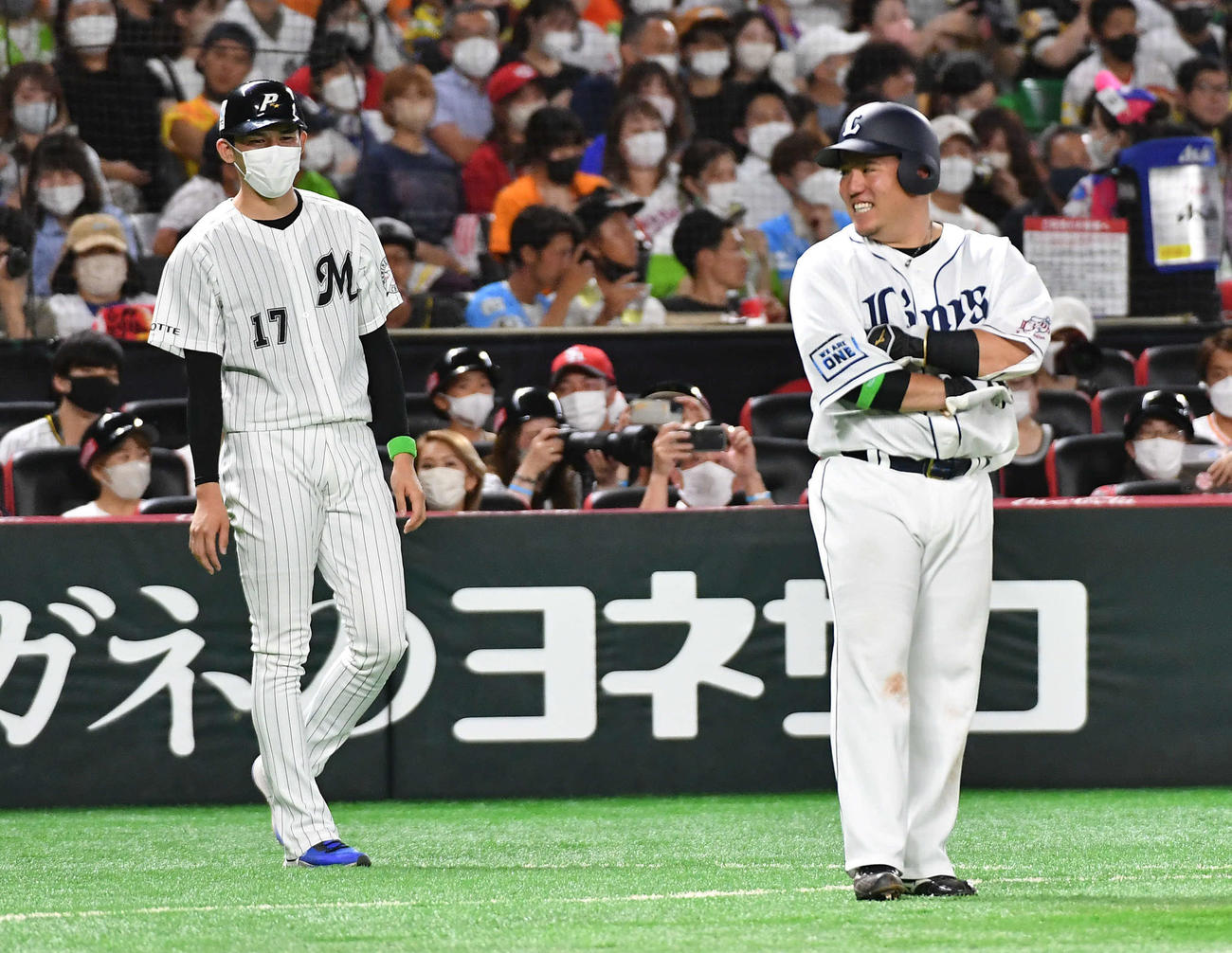 全パ対全セ　6回裏全パ2死満塁、オリックス宗の同点適時打で三塁へ進塁した西武山川（右）と談笑するロッテ佐々木朗（撮影・岩下翔太）