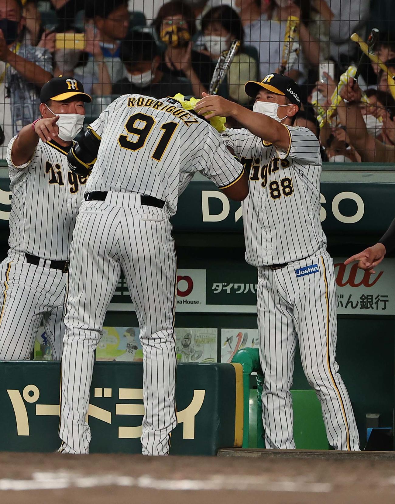 阪神対ヤクルト　4回裏阪神無死、左越えソロ本塁打を放ったロドリゲスは矢野監督に本塁打メダルを掛けてもらう（撮影・上田博志）