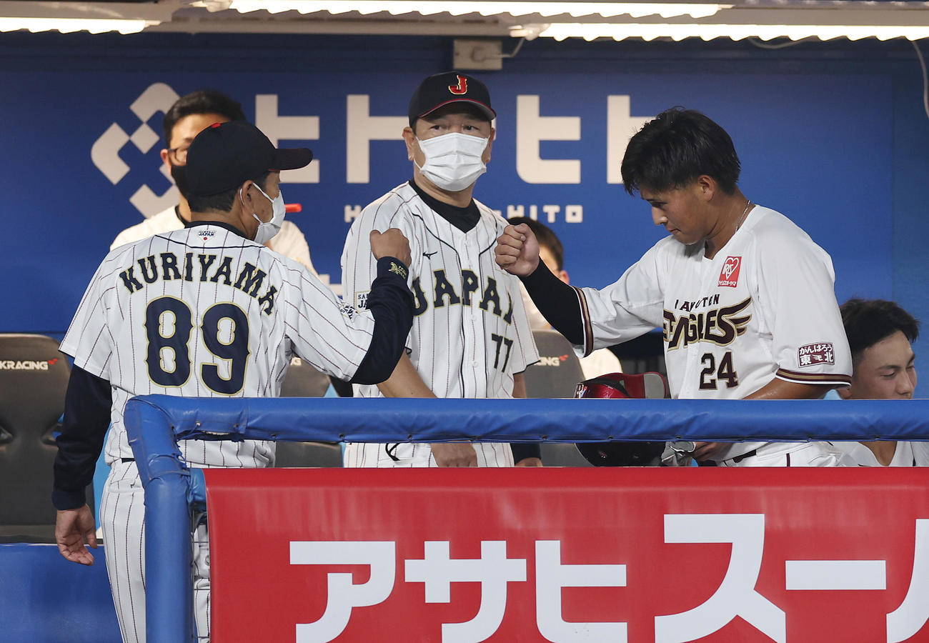 U23NPB選抜対大学・社会人選抜　3回裏の攻撃を終え適時二塁打を放ったU23NPB選抜黒川（右）は栗山監督とグータッチ（撮影・垰建太）