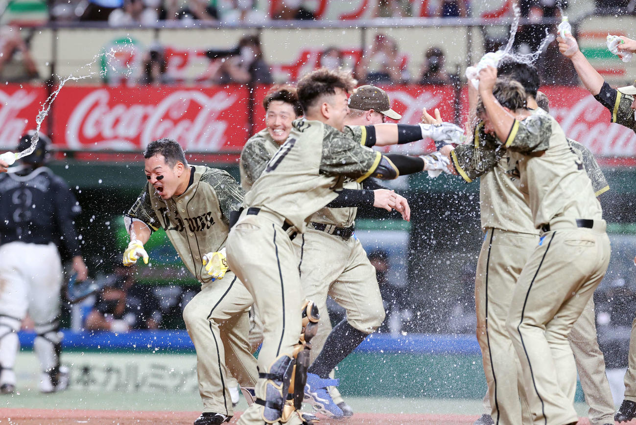 西武対ロッテ　10回裏西武無死、サヨナラソロ本塁打を放った川越（左）は水シャワーをかけるチームメートから逃げる（撮影・浅見桂子）