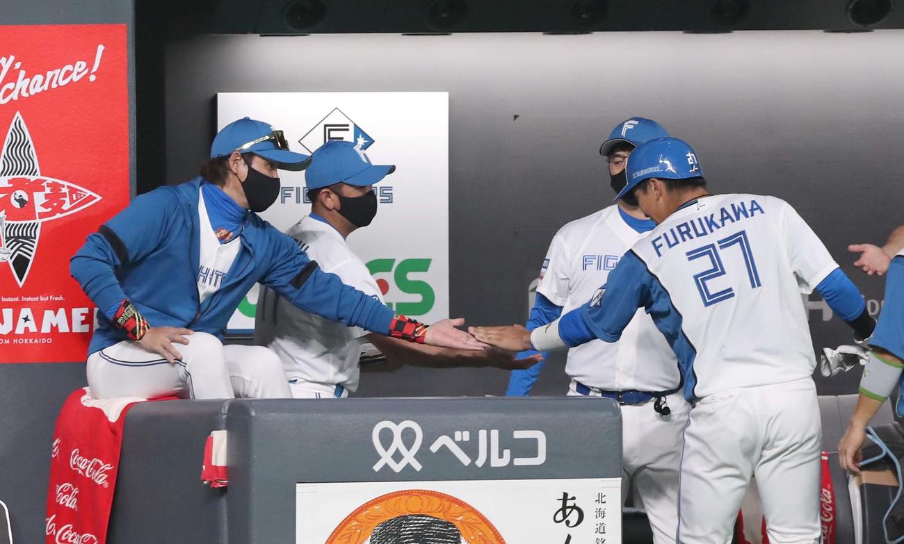日本ハム対西武　2回裏、適時打を放った古川裕とタッチする新庄監督（撮影・黒川智章）