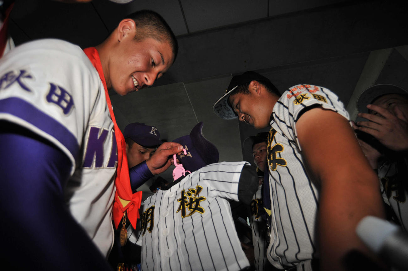 7月24日、秋田県大会決勝戦を終え、山口航輝(右)は吉田輝星に明桜のお守りを贈る