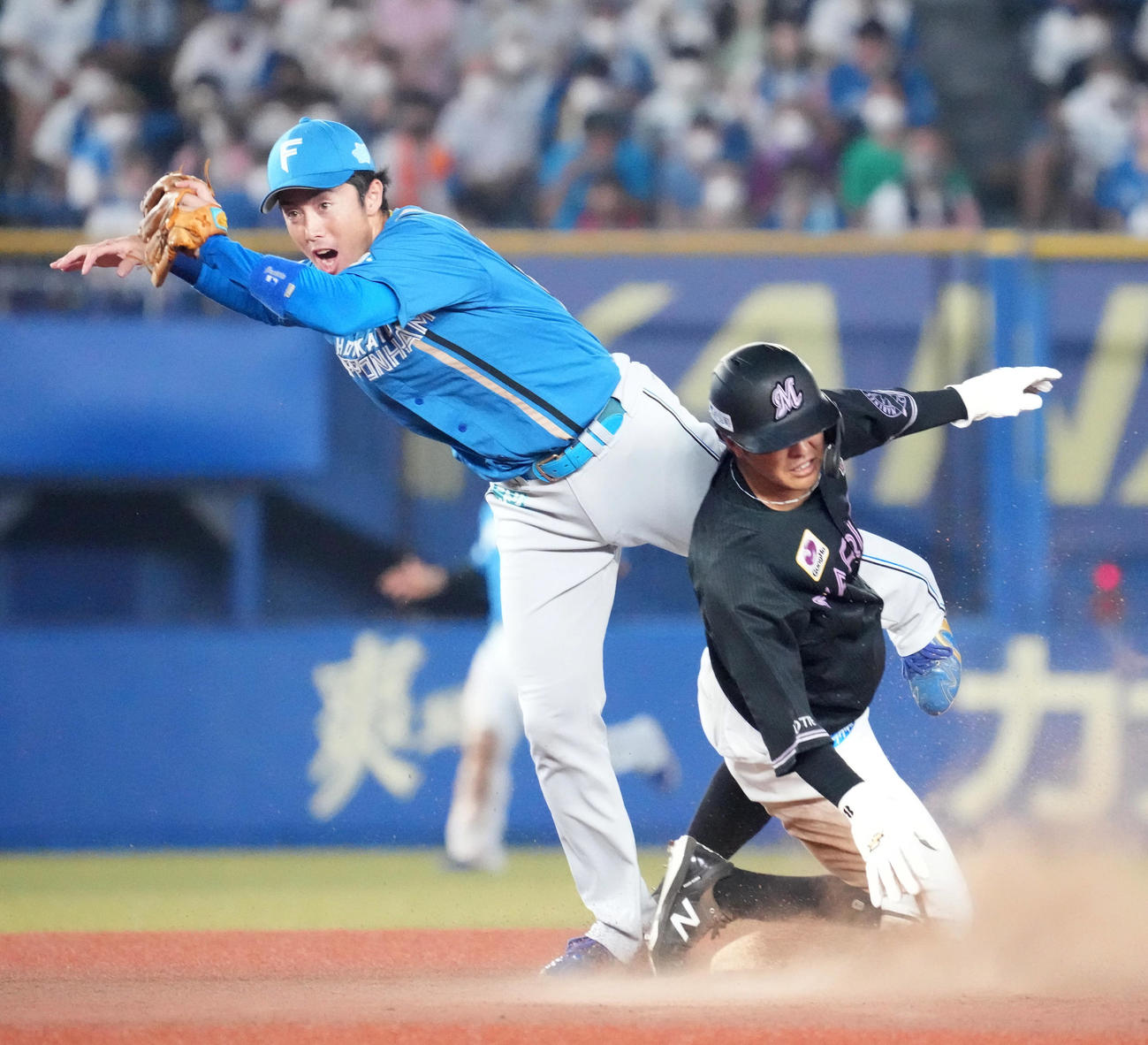 ロッテ対日本ハム　5回裏ロッテ1死一、二塁、中村奨（右）は二塁盗塁を狙うもタッチアウト。左は日本ハム谷内（撮影・小沢裕）