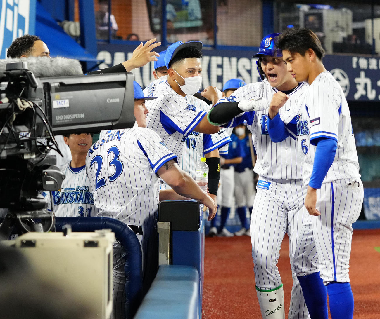 DeNA対巨人　8回裏DeNA無死、勝ち越しソロ本塁打を放ち、中継カメラに向かい「デスターシャ」決める佐野（右から2人目）（撮影・江口和貴）