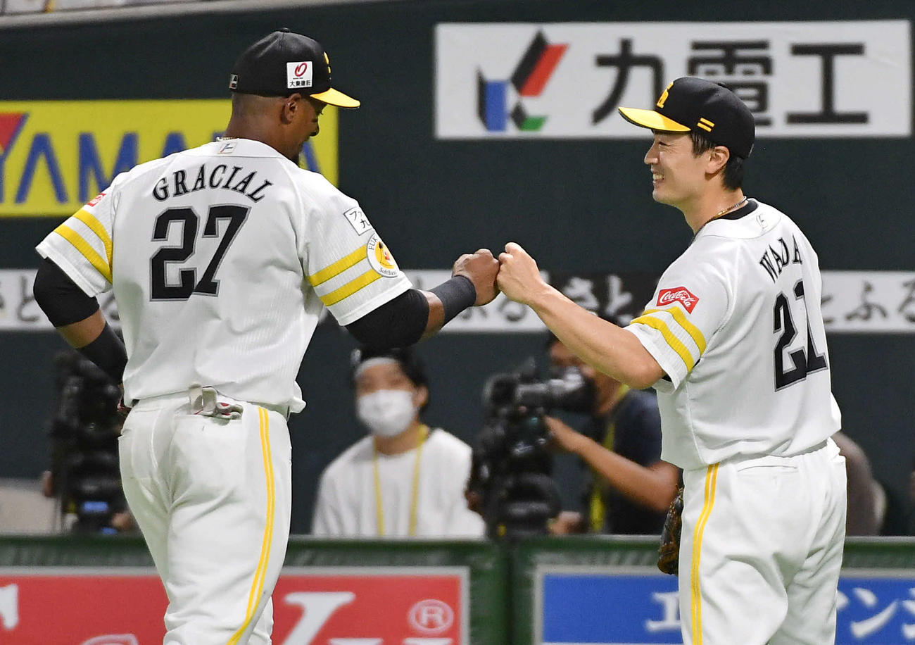 ソフトバンク対日本ハム　5回表を終え、グラシアル（左）と笑顔でグータッチを交わしながらベンチへ戻る和田（撮影・岩下翔太）