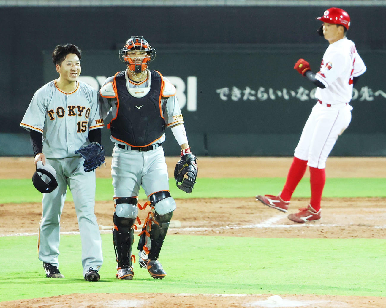 広島対巨人　最終打者の西川を二ゴロで抑え、広島に勝利し笑顔を見せる大勢（左）と大城。後方は大盛（撮影・河田真司）