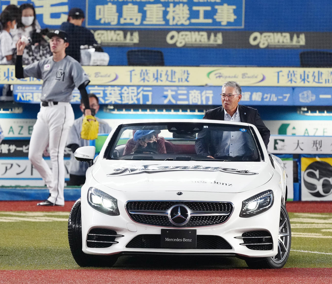 試合前、始球式に臨む小宮山氏はリリーフカーで登場。後方左はロッテ先発の佐々木朗希（撮影・江口和貴）