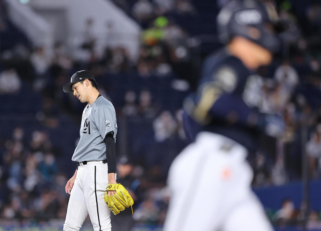 ロッテ対オリックス　7回表オリックス無死、吉田正（手前）に安打を許し首をかしげる佐々木朗（撮影・垰建太）