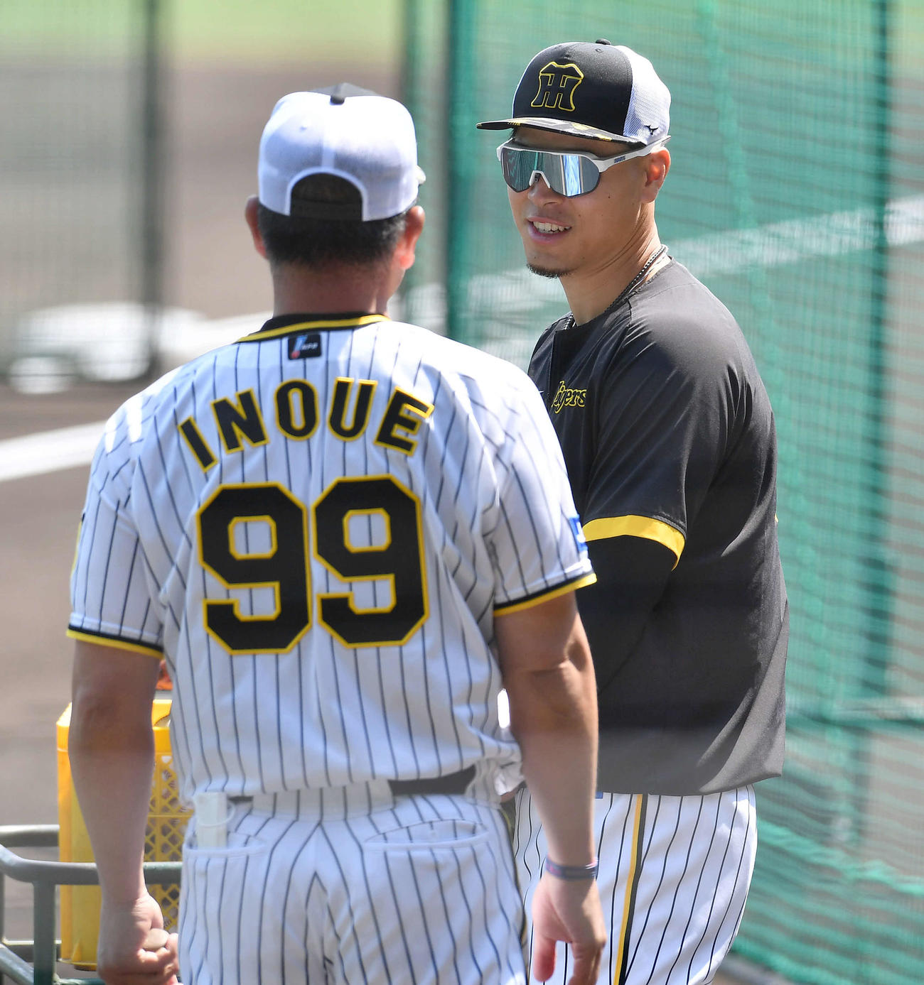 井上一樹ヘッドコーチ（左）と話す佐藤輝明（2022年5月25日撮影）