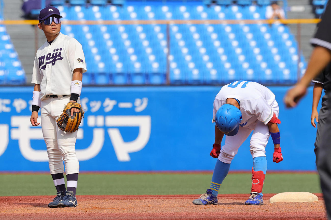 明大対東大　2回裏東大1死二塁、左適時二塁打を放ち喜ぶ松岡泰。左は明大・村松（撮影・野上伸悟）