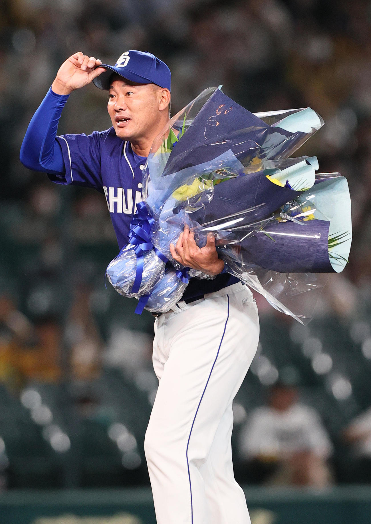 阪神対中日　今シーズンで引退する中日福留は花束を手にファンの声援に応える（撮影・上山淳一）