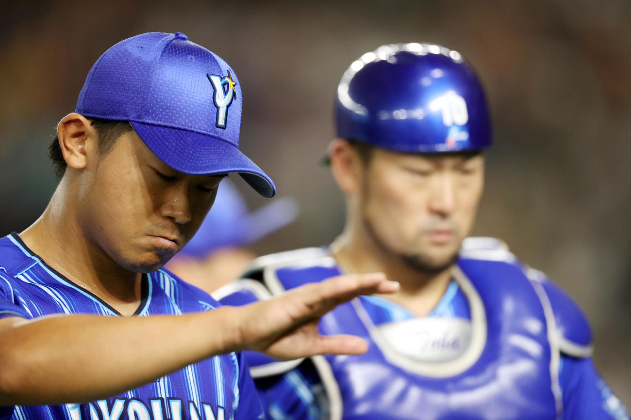 巨人対DeNA 6回裏を終え、悔しそうな表情でベンチに戻る今永（左）と戸柱（撮影・狩俣裕三）