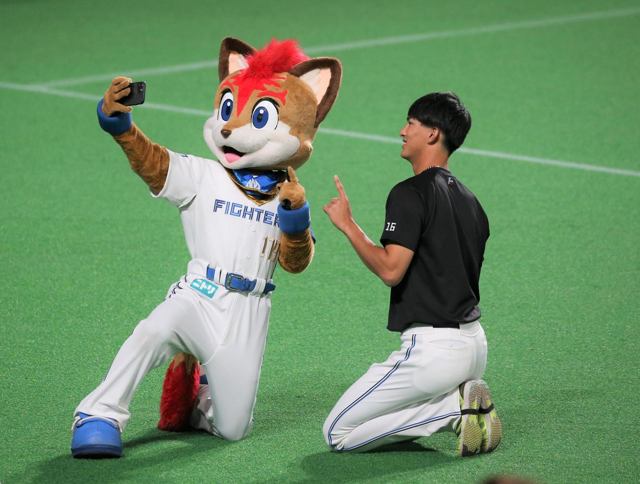日本ハム対西武　マスコットのフレップと「自撮り」する達（撮影・黒川智章）
