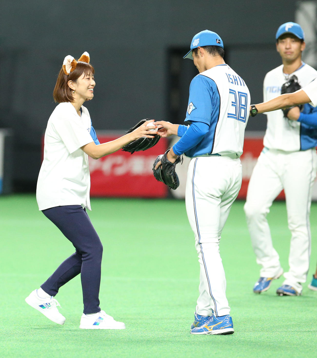 日本ハム対楽天　ファーストピッチセレモニーを務めた元バドミントン代表の潮田（左）は石井から記念ボールを受けとる（撮影・佐藤翔太）