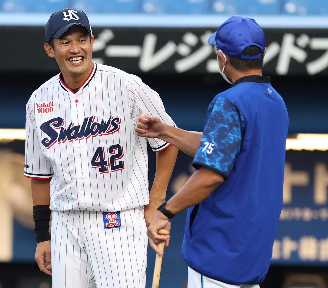 ヤクルト対DeNA　試合前、石井コーチ（右）と話をする坂口（撮影・狩俣裕三）