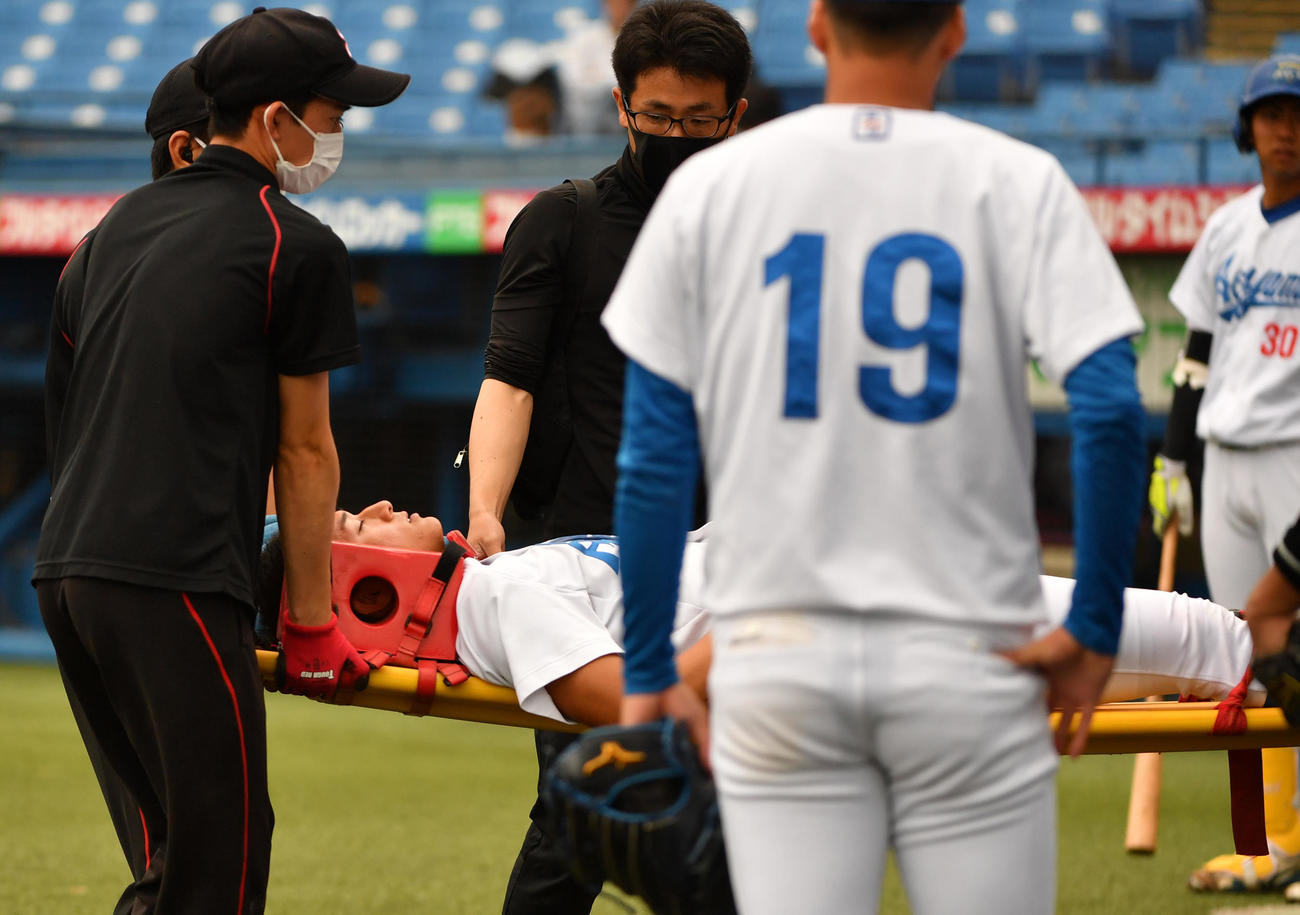 青学大対中大　頭部に死球を受けた青学大・佐々木は、立ち上がれず担架で運ばれた（撮影・柴田隆二）