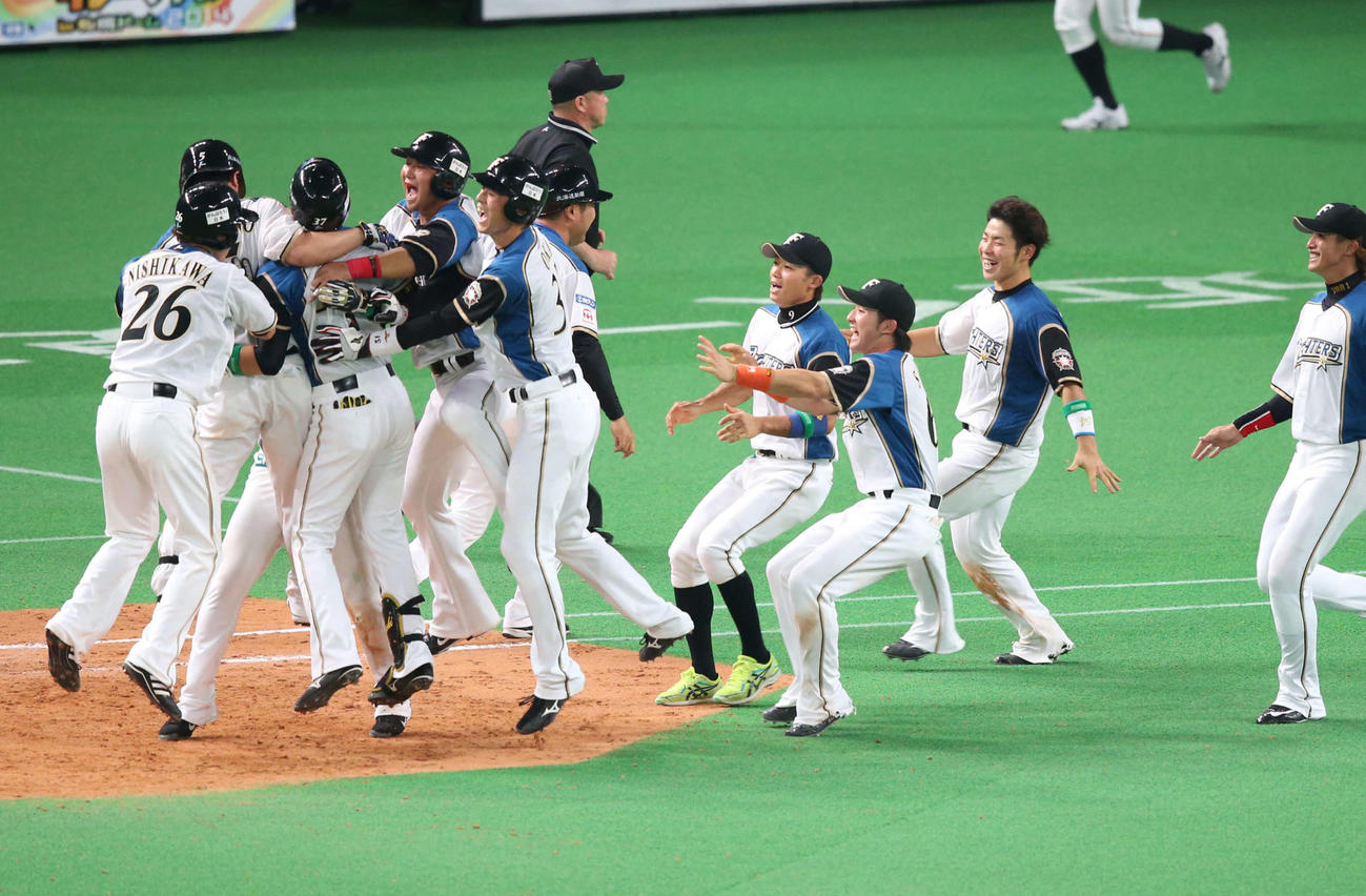 12回裏日本ハム1死満塁、サヨナラ打を放った小谷野（左から2人目）に中田（同4人目）らナインが飛びついて歓喜の抱擁