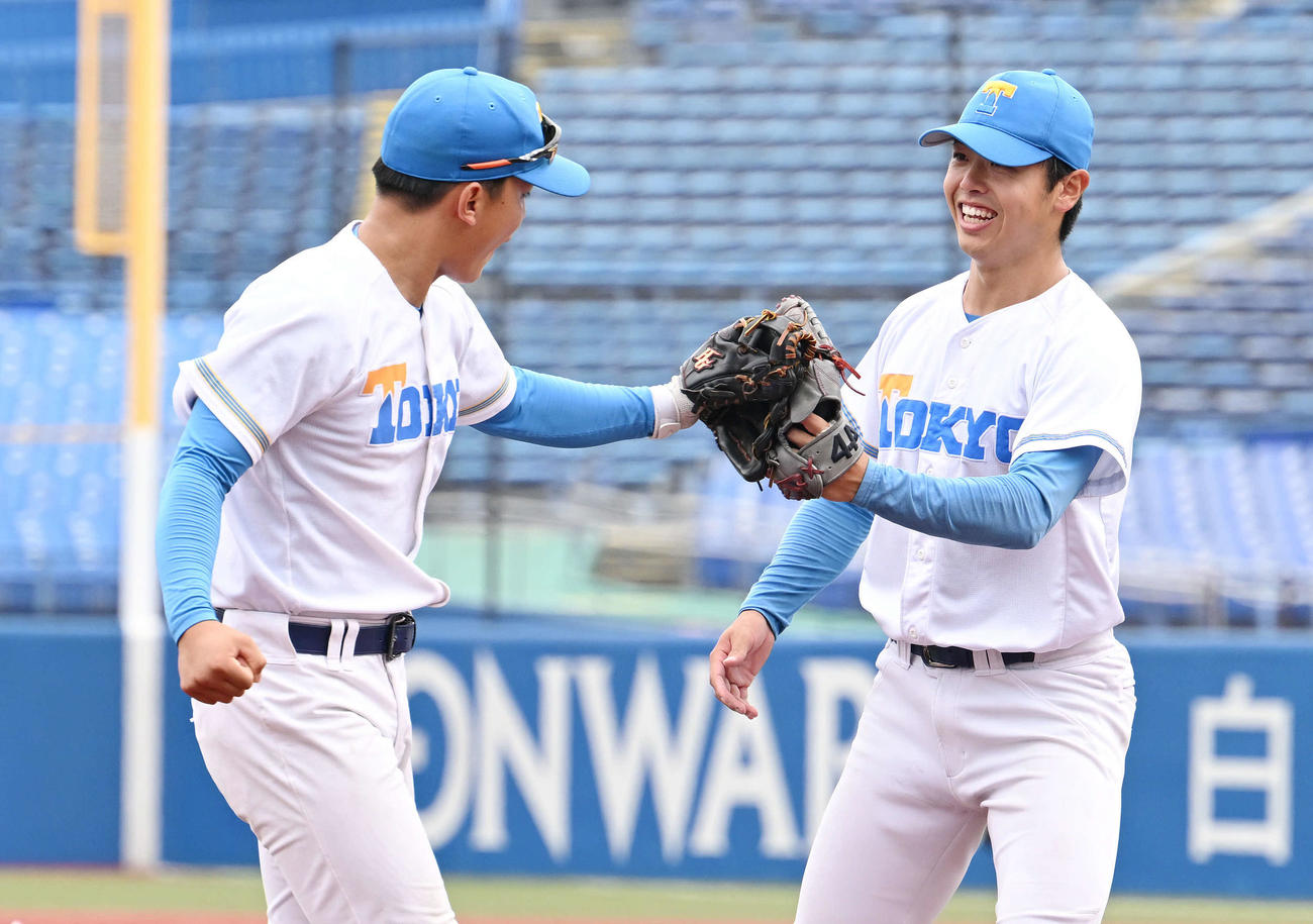 東大対立大　3回裏立大1死一、二塁、西川晋を併殺打に仕留めた井沢（右）は笑顔でナインとタッチを交わす（撮影・滝沢徹郎）
