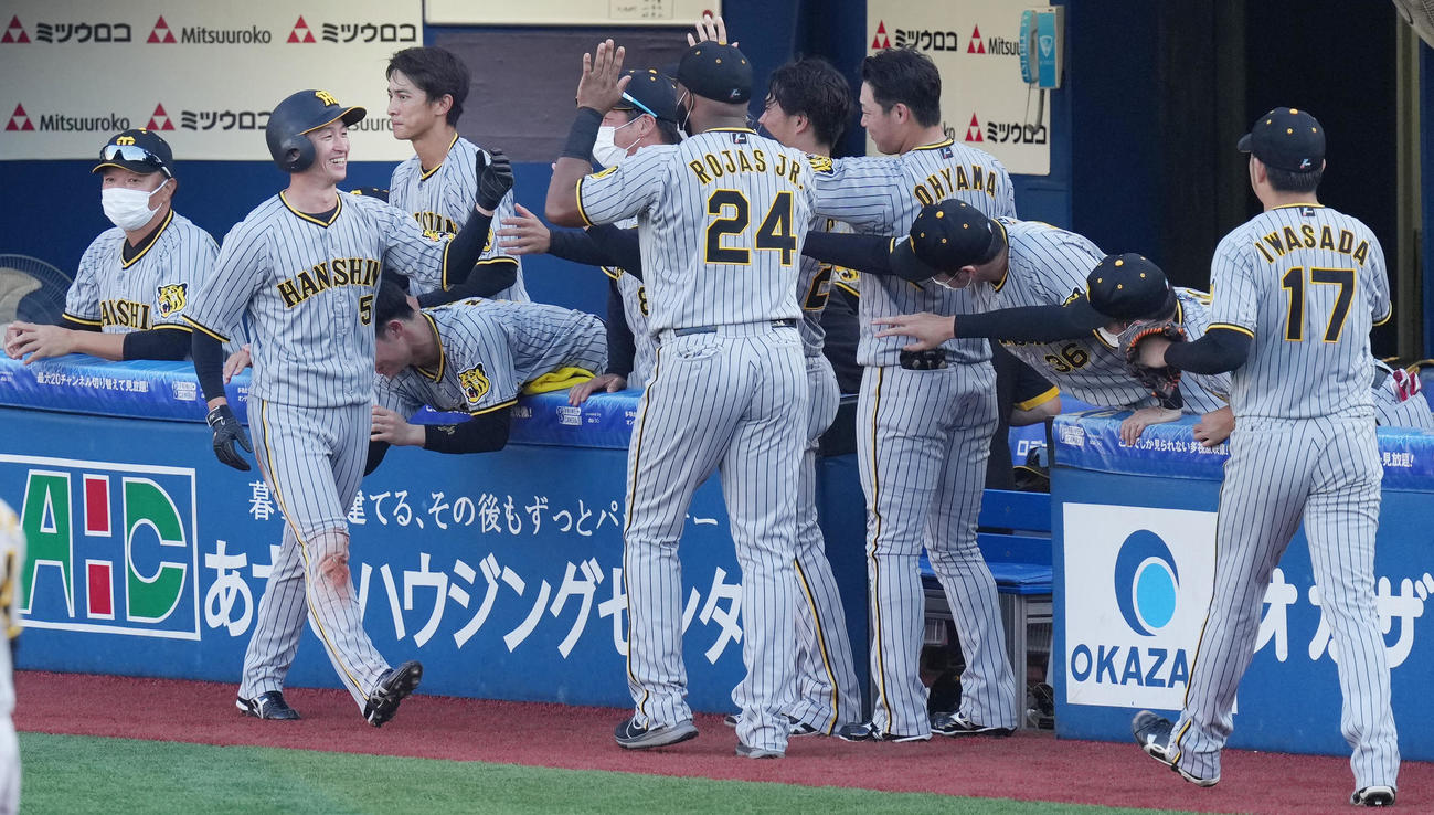 DeNA対阪神　6回表阪神1死二塁、原口の左適時打で生還した近本（左から2人目）はナインと笑顔でハイタッチ（撮影・鈴木みどり）