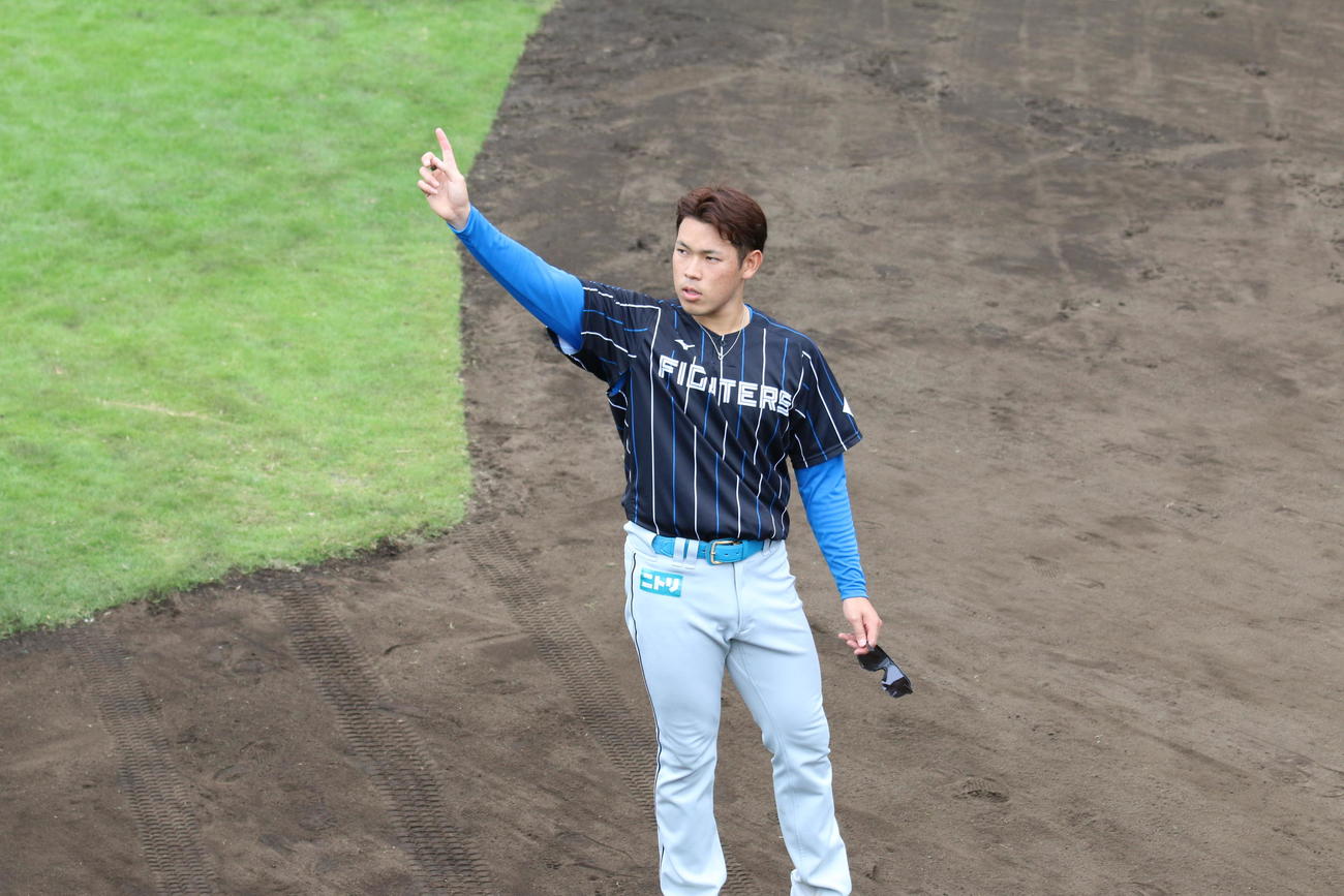 練習中に人さし指を突き上げる日本ハム根本（撮影・田中彩友美）