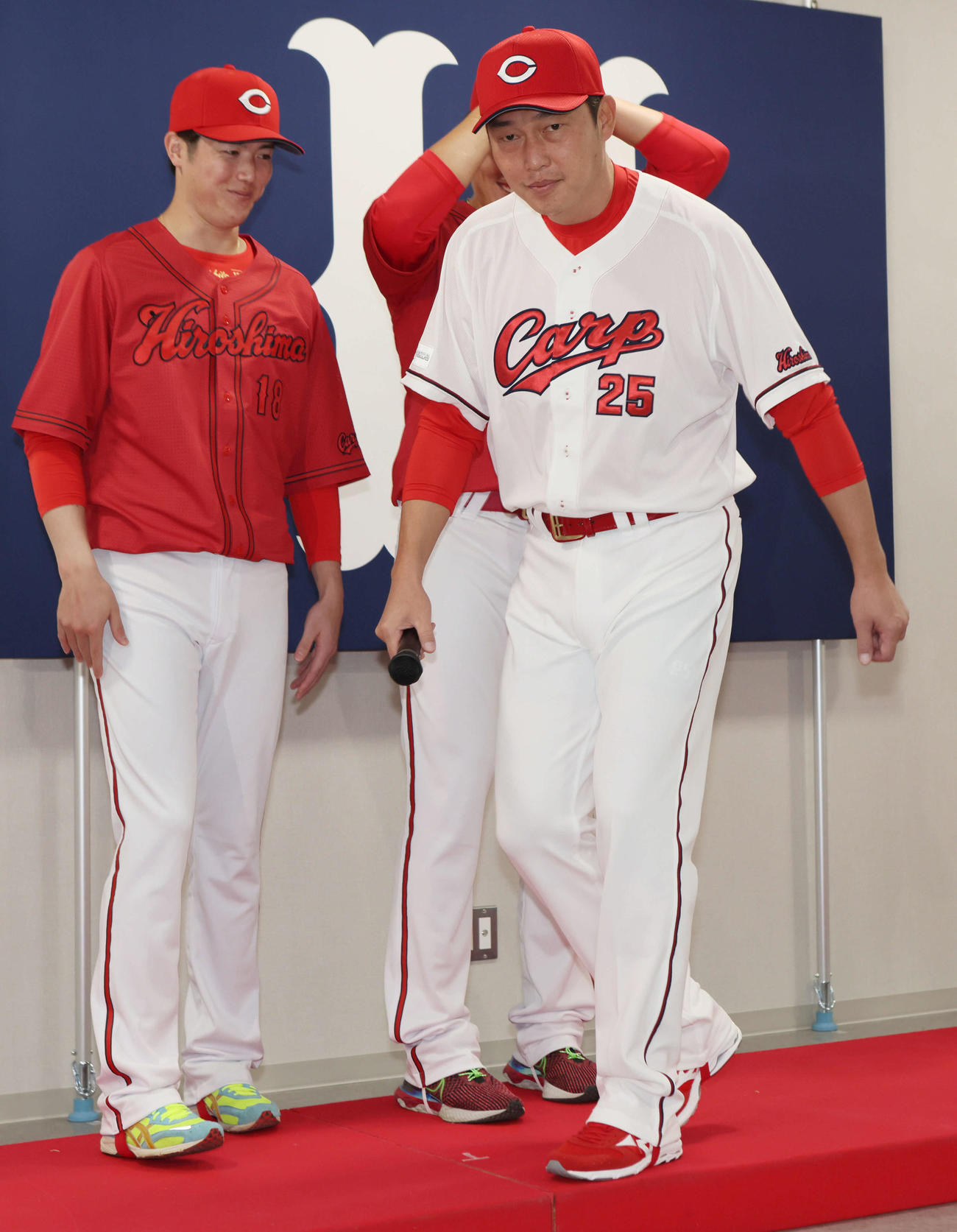 新ユニホーム発表を終えて会場を後にする新井貴浩新監督（右）と森下（左）（撮影・加藤孝規）