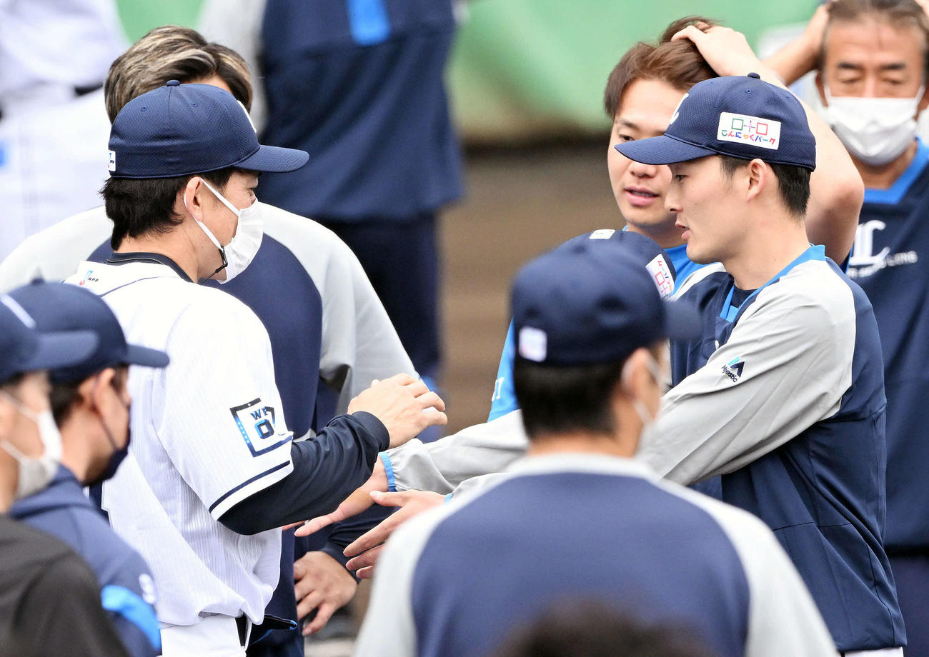 練習前に西武松井新監督（左）は源田と話す（撮影・滝沢徹郎）　