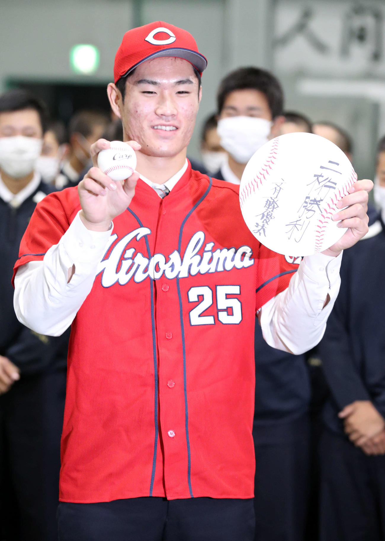 広島からドラフト1位指名を受けた苫小牧中央の斉藤は「二桁勝利」としたため記念撮影に応じる（撮影・佐藤翔太）