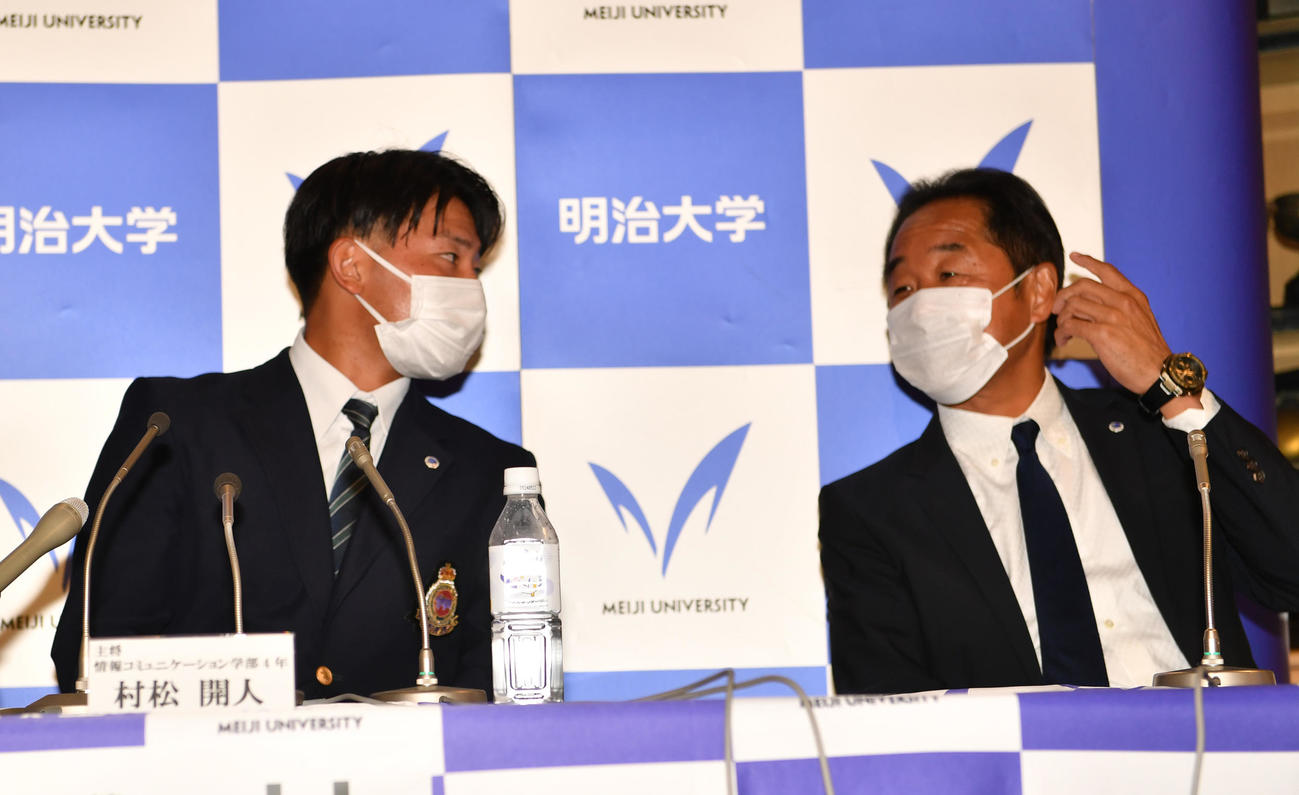 ドラフトで中日から2位に指名された明大・村松（左）は田中監督から祝福される（撮影・柴田隆二）