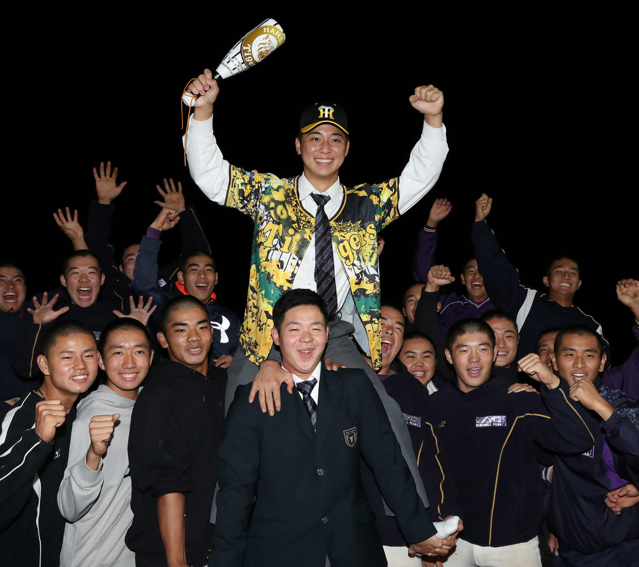 阪神から3位指名を受けた井坪は、チームメートに担がれ笑顔を見せる（撮影・丹羽敏通）