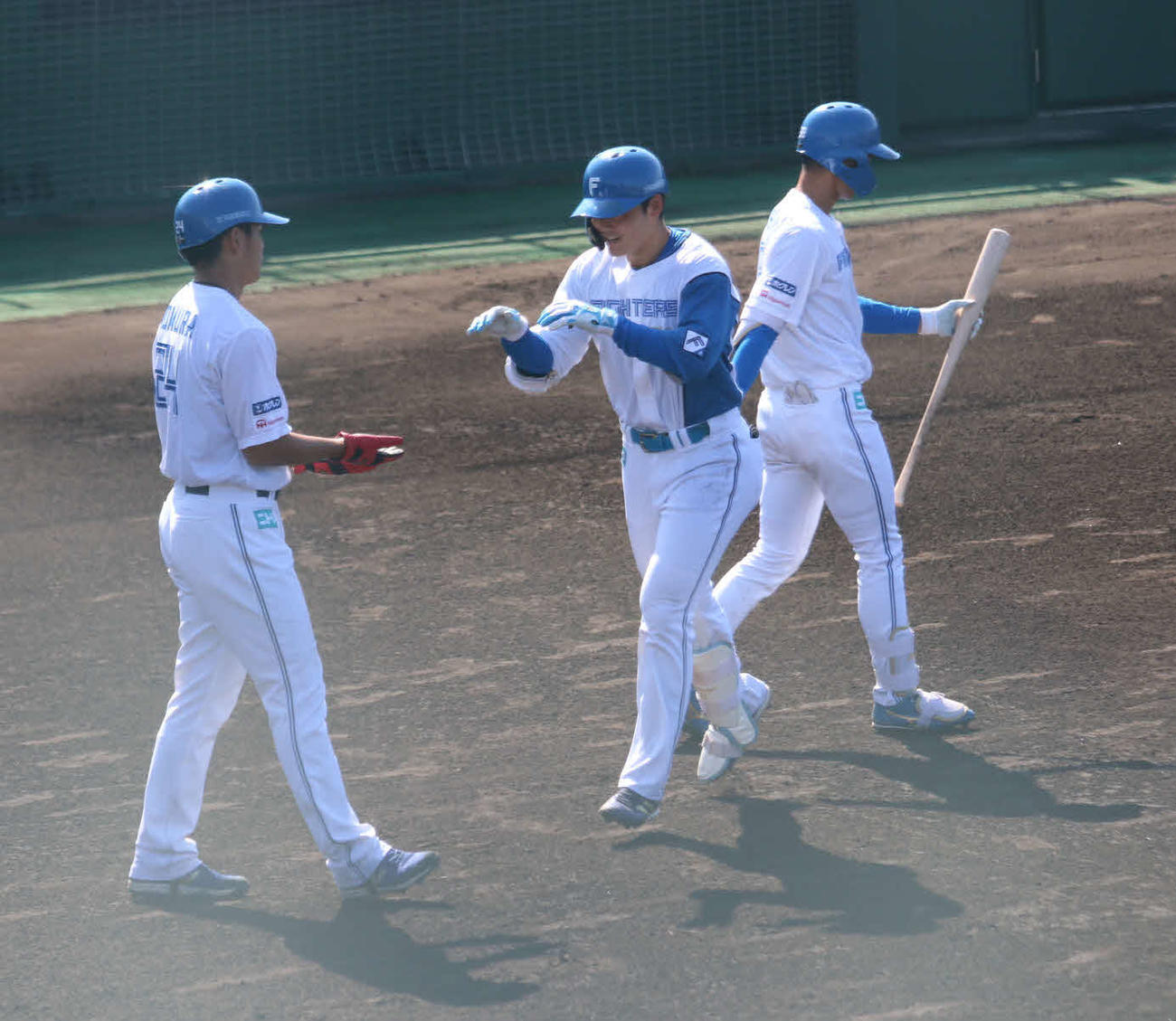 1回、左越えに先制2ランを放ち、出迎えた日本ハム野村（左）とハイタッチする清宮（撮影・中島宙恵）