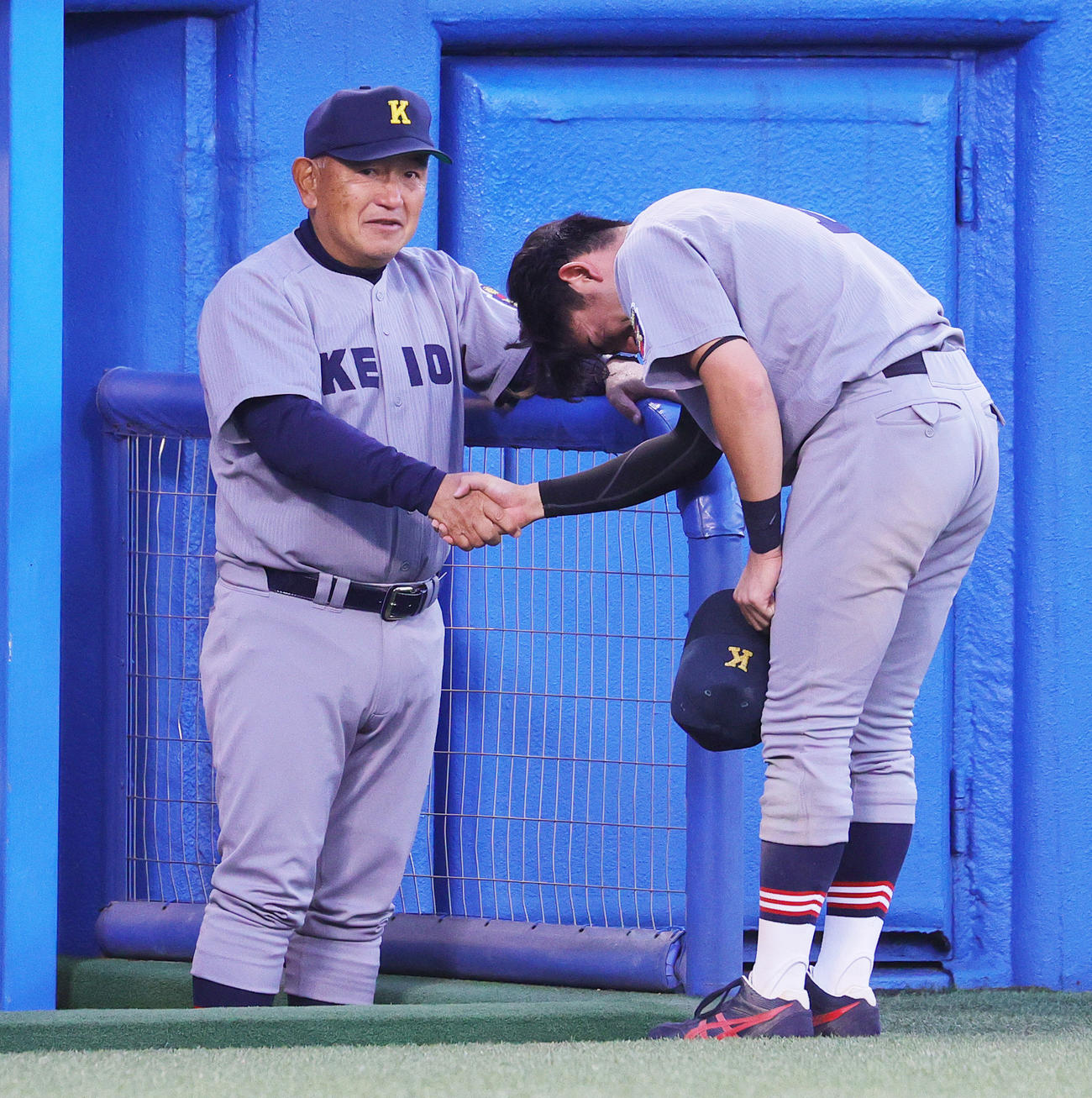 早大対慶大　優勝を逃した慶大・萩尾（右）は堀井監督と涙で握手（撮影・野上伸悟）
