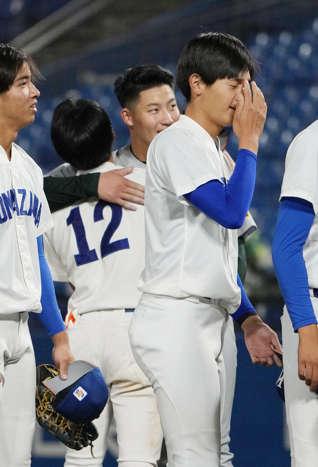 駒大対専大　専大3番手で登板した菊地吏（中央）は1部残留を決めた駒大・林琢と健闘をたたえ合う（撮影・小沢裕）