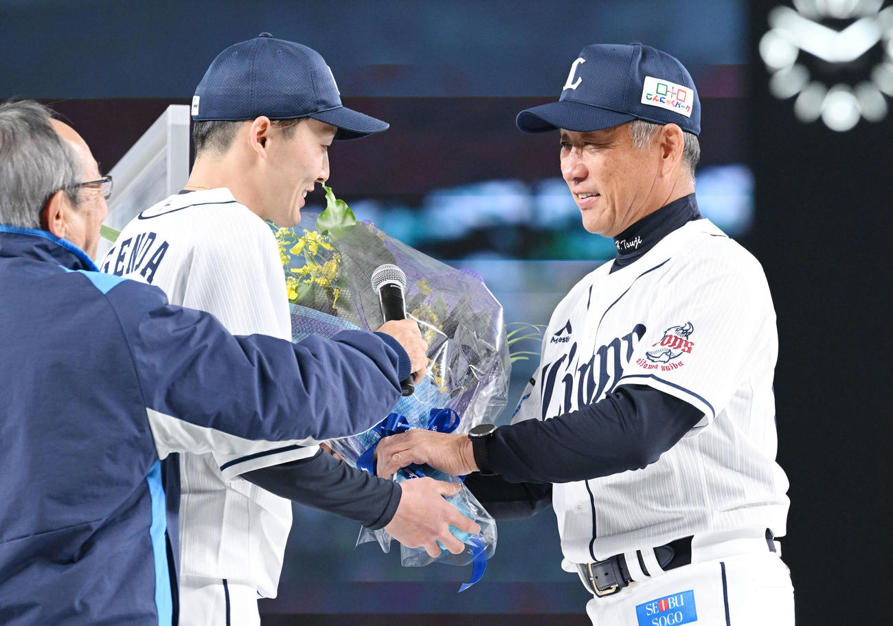 トークイベントを終えた西武辻前監督（右）は源田から花束を受け取る（撮影・滝沢徹郎）