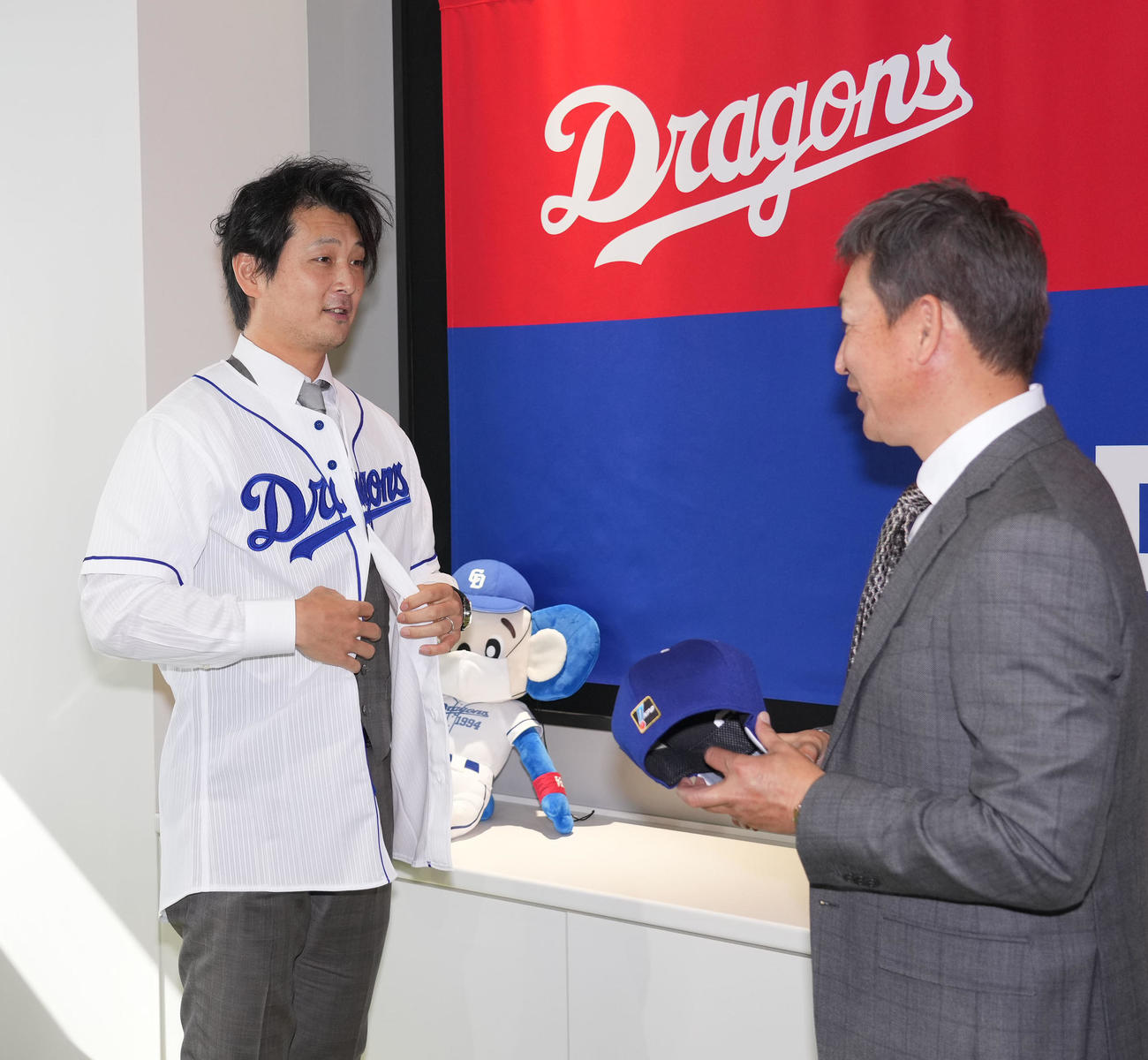 会見後、ユニホームに袖を通す涌井（左）右は立浪監督（撮影・森本幸一）
