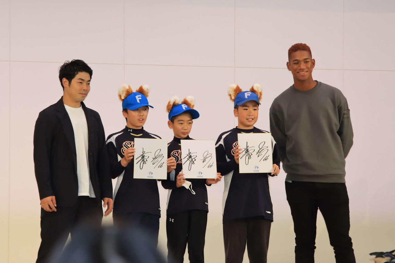 千歳みどり台小を訪れた日本ハム近藤（左端）と万波（右端）は小学生と記念撮影する（撮影・保坂果那）