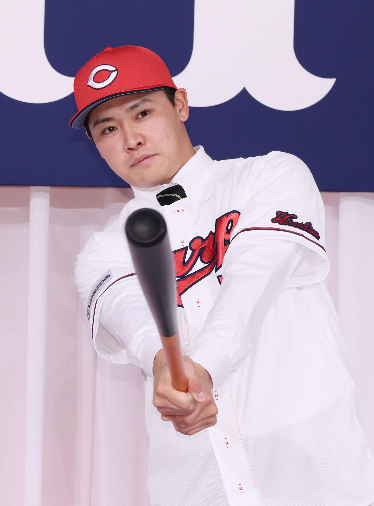 広島新入団選手発表会見　ポーズを決めるドラフト7位の久保（撮影・加藤孝規）