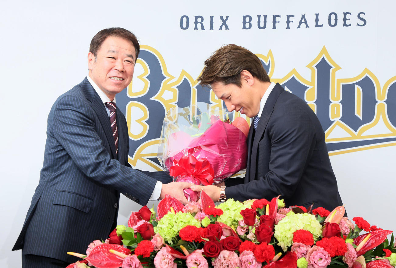 レッドソックスへのポスティング移籍が決まり福良GM（左）から花束を受け取る吉田正（撮影・加藤哉）