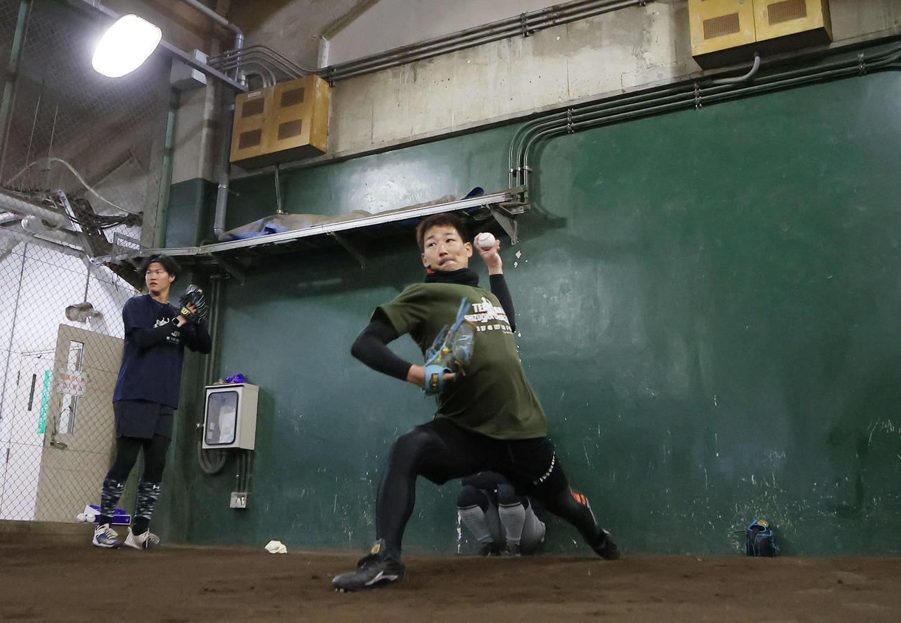 自主トレでブルペン投球する阪神の岩崎（右）と及川（撮影・足立雅史）