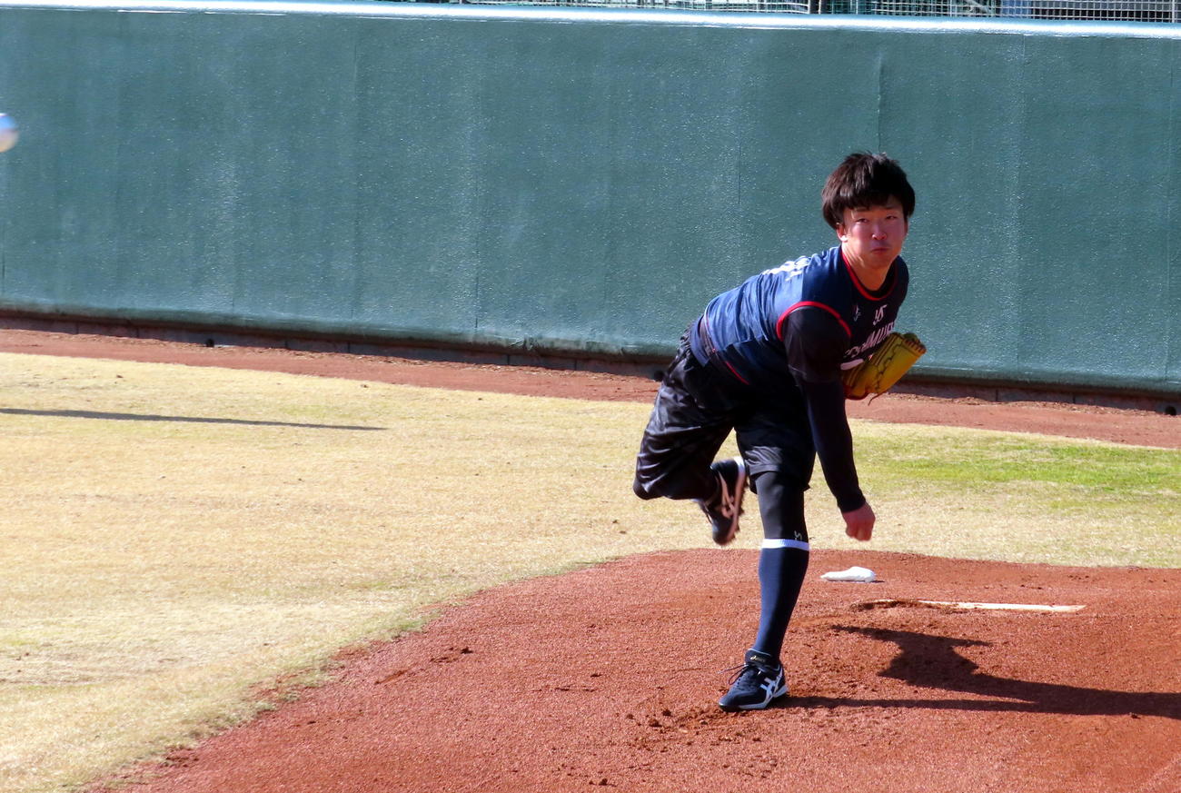 ブルペンで左足を振り子のように揺らしながら投球するヤクルト吉村貢司郎投手（撮影・三須一紀）