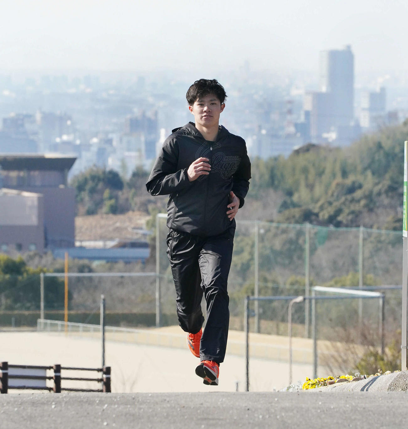 岡崎市の街並みを背にランニングする阪神中野（撮影・森本幸一）