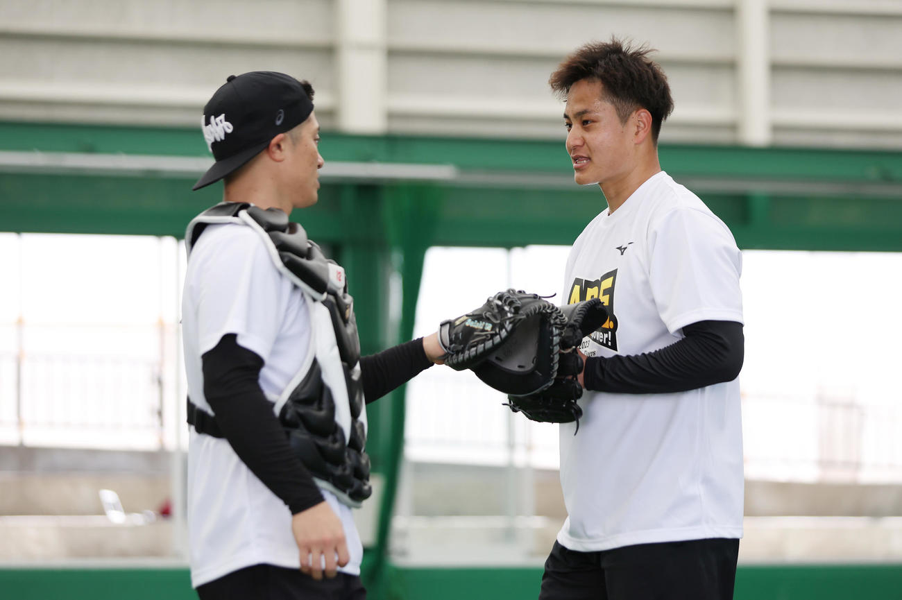 ブルペンでの投球練習を終え阪神坂本（左）と言葉を交わす大竹（撮影・前田充）