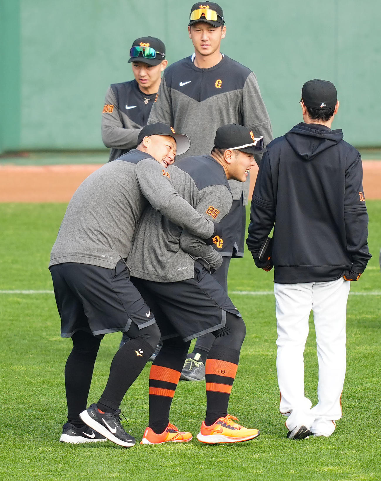 練習前、巨人中田翔（左）から抱きつかれる岡本和（撮影・江口和貴）