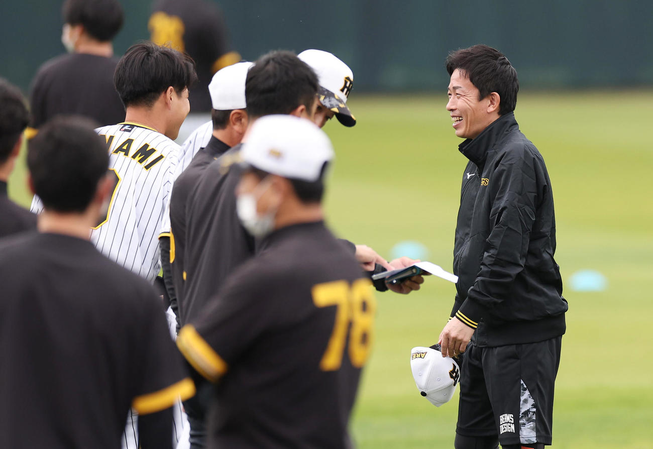 阪神ナインらと笑顔であいさつする赤星臨時コーチ（右）（撮影・前田充）