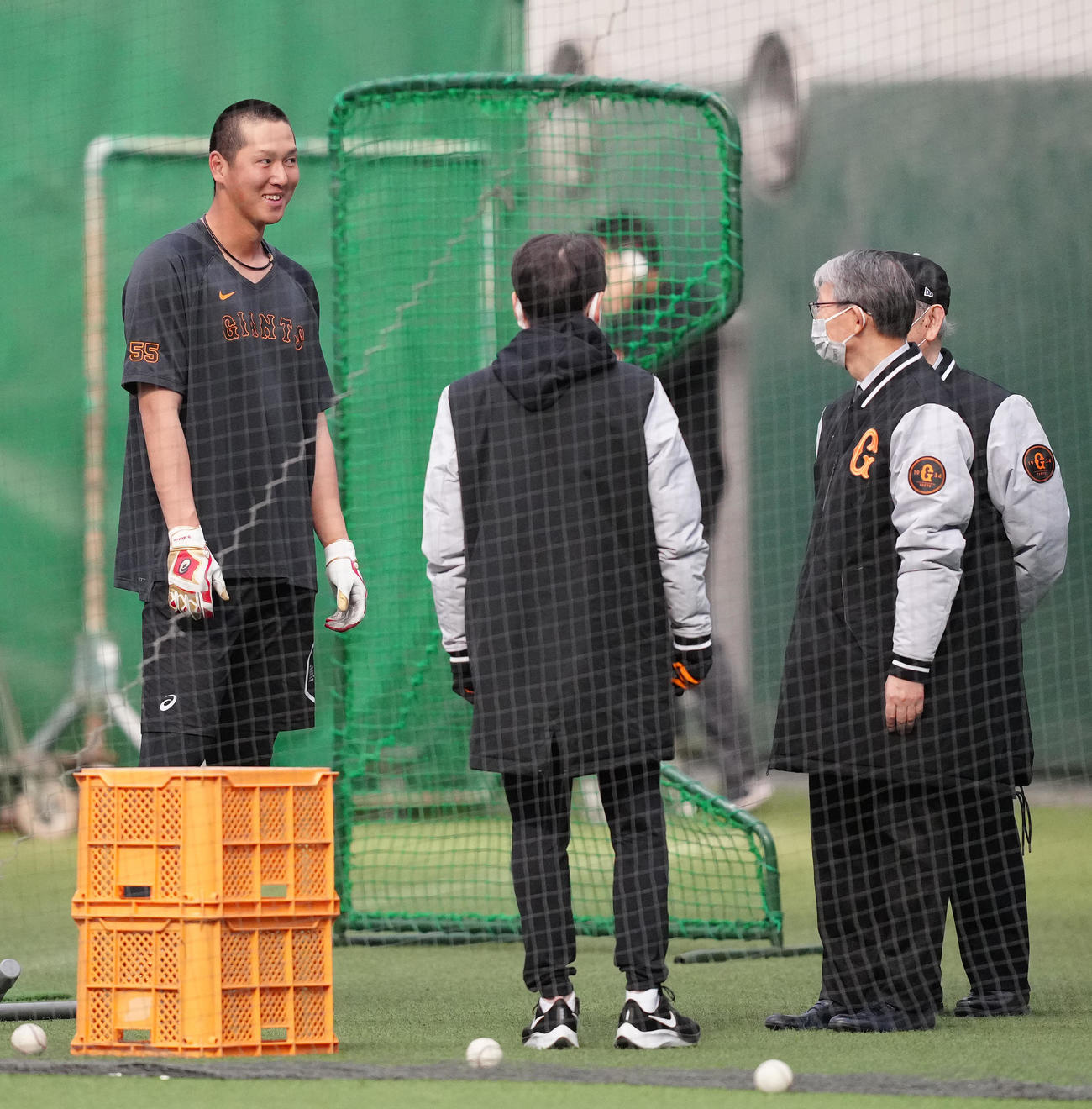 早朝練習で巨人山口オーナー（右手前）らから声をかけられる秋広（左）（撮影・江口和貴）