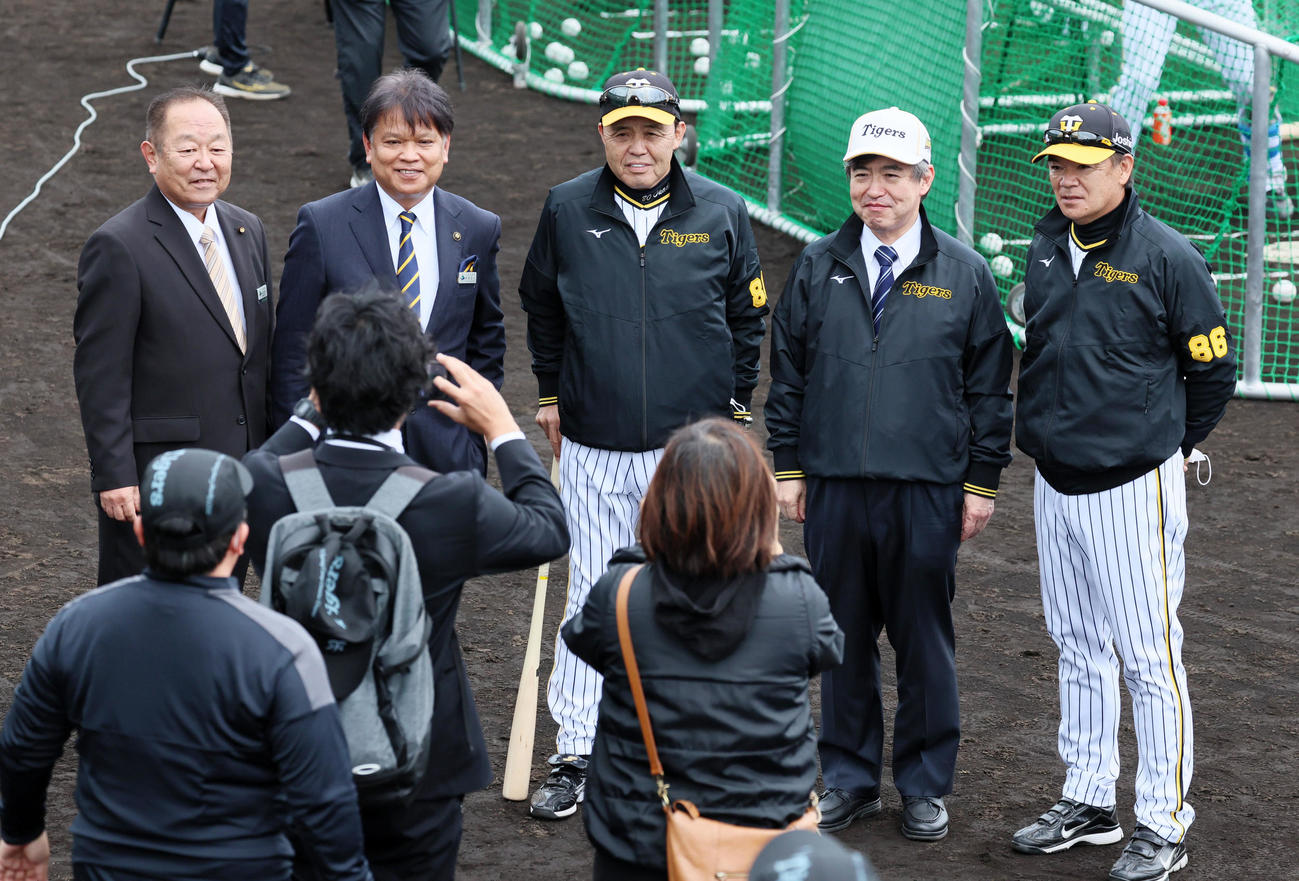 うるま市の中村市長と記念写真に納まる岡田監督。左端はうるま市の比嘉市議会議長、左から4人目は杉山オーナー、右端は和田2軍監督（撮影・加藤哉）