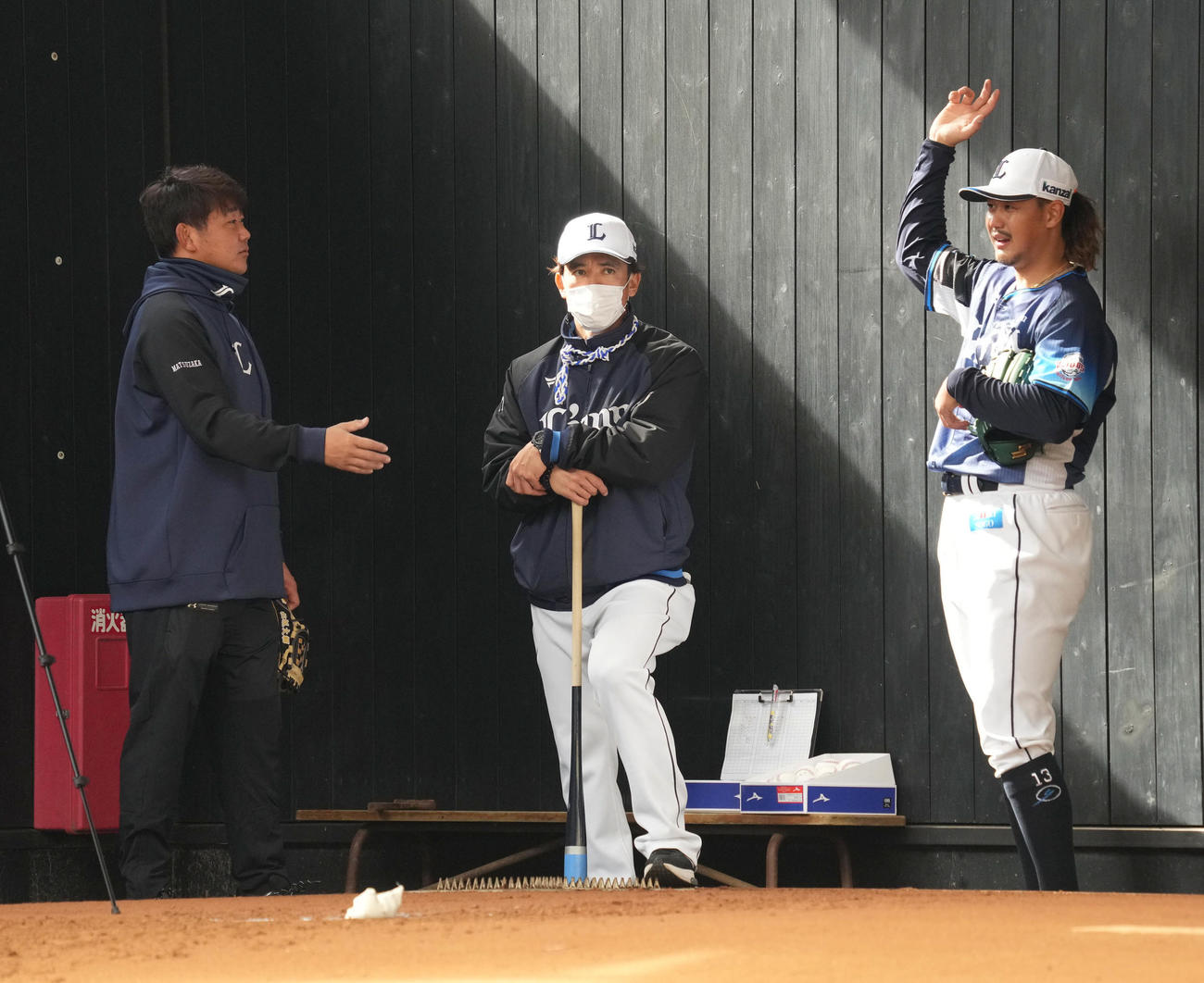 ブルペン投球を終えた西武高橋（右）は臨時投手コーチの松坂氏（左）の指導を受ける。中央は西武松井監督（撮影・小沢裕）